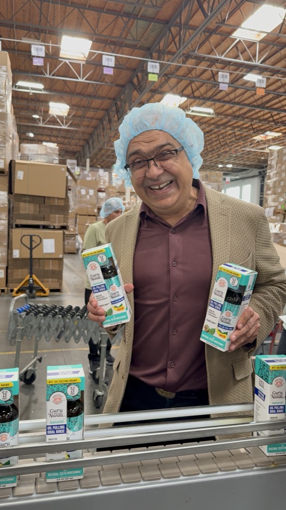 Puneet Nanda holding GuruNanda products in the warehouse