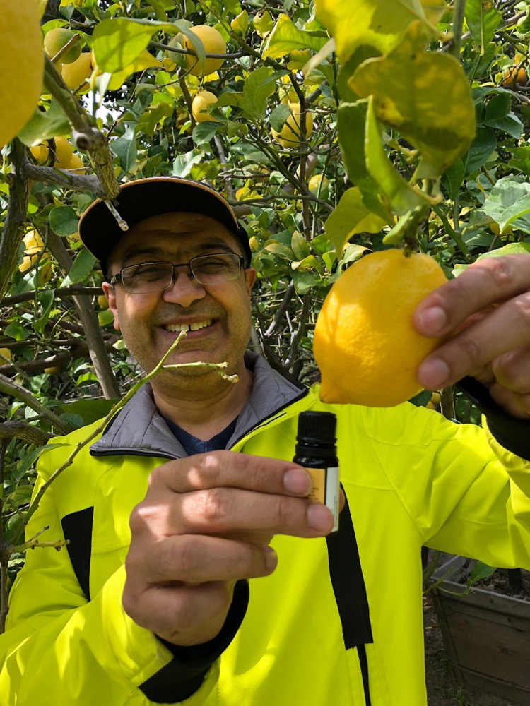 Puneet Nanda in a citrus orchard sourcing lemon oil
